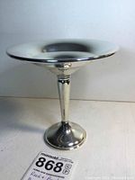 Full front view of the bon bon candy dish showing the elevated stem and broad bowl with flared rim.