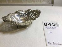 View of the oval sterling silver pierced nut bowl showing ornate pierced edge and decorative feet.