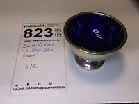 Sterling silver salt cellar with blue glass bowl insert inside, showing overall shape and size.