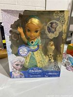 Front view of the boxed Disney Frozen Snow Glow Elsa doll with Olaf, showing packaging and product in new condition.