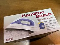 Original box of Hamilton Beach Steam Storm Plus nonstick iron with product information and features printed.