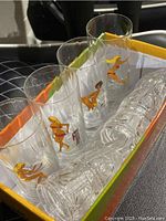 Multiple Soflex decor glasses including four large, six medium and five small shot glasses with vintage pin-up woman decals