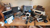 Overview of desktop items including radios, clock radios, cordless phones, calculators, remote controls, and accessories.