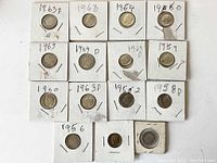 Top-down photo showing 17 Roosevelt dimes mounted individually in cardboard 2x2 holders with handwritten years and mint marks.
