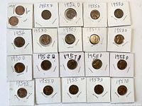 21 carded wheat pennies laid out in four rows with visible handwritten dates and mint marks on coin holders.