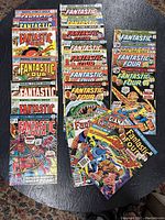 Overhead view of three stacks totalling 24 comics showing full lot