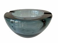 Clear smoky gray thick crystal glass ashtray with three cigarette rests shown on a white background.