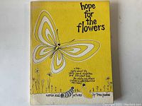 Front cover showing yellow background with butterfly and caterpillar illustration and title 'hope for the flowers'.