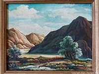 Close-up of the vintage southwestern landscape oil painting depicting mountains, trees, and clouds.