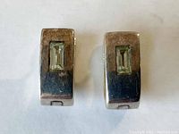 Front view of the pair of sterling silver clip-on earrings, each featuring a rectangular aquamarine stone centered on the earring face.