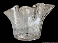 Front and side view showing clear glass ruffled edge and textured bubbles.