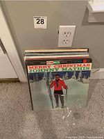 Vinyl record albums stack led by Merry Christmas by Johnny Mathis album