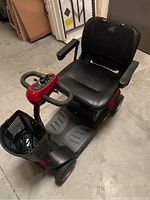 Front-left perspective of scooter showing frame, seat, wheels