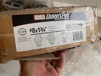 Label on the box showing Senco Duraspin brand, #8 x 1 3/4 inch flooring screws, details including #2 square flat head, Type 17 cut point, yellow zinc finish, coarse thread, 4000 screws per box, for floor sheathing use.