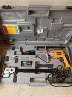 Photo of open plastic carrying case containing Senco DuraSpin self feeding screw tool with attached yellow DeWalt drill and accessories.