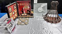 Photo showing entire lot including pasta maker on left, decorative photo box in center, wall clock on right, ornate metal wall shelf and an unidentified metal object