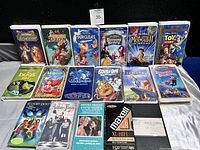 Photo showing a grouped collection of VHS tapes mostly Disney titles and some other movies.