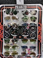 Photo of entire sunglasses display board with 12 pairs of polarized sunglasses mounted for sale.
