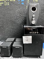 Speakers and subwoofer with control pod showing front and top surface with knobs