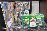 Photo of an open baseball card binder showing multiple vintage MLB cards and the 1991 Score Collector Set box beside it