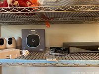 Shelf view showing ecobee box, security cameras, DVR and cables