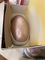 Kahuna LED face mask and beige drawstring pouch in foam-lined box