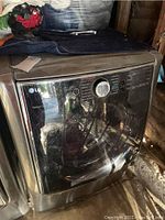 Full view of LG front-load dryer in storage area