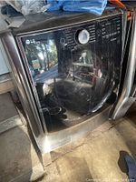 Front and side view of stainless steel front-load washing machine showing door and control panel.