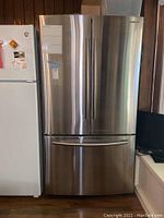 Front exterior view showing brushed stainless steel finish, French doors and bottom freezer drawer