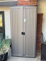 Front view of closed cabinet showing double doors and lock hasp