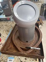 Dyson fan with three wicker trays displayed on countertop