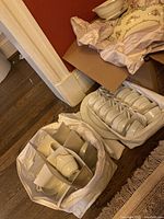 Top view showing boxed plates and bowls in a protective carrying container with paper dividers.