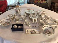 Wide overview of entire dinnerware set arranged on table