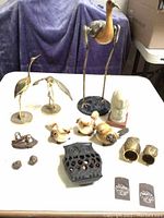 Overview of the lot showing all bird figurines and decorative pieces on a white table.