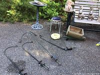 Four metal clamp‐on deck stands (three single‐hook, one double‐hook) arranged in foreground