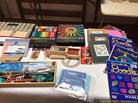 Photo showing Prismacolor colored pencil sets, pastel sets, doodle pads, and wooden drawing tool kits.