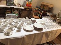 Full lot laid out on table showing all china and glassware