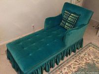 Side view of teal fainting couch showing full length and ruffled skirt underframe