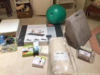 Full lot showing all items including folding mat, yoga mat, stretch step, weights, bands, stability ball, power cord handles, stretch pillow.