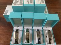 12 brand new quartz watches in turquoise boxes, leather straps in various colors and studded design.