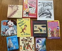 Top view of 10 vintage kids books and a sheet of Melissa & Doug temporary tattoos on wooden floor.
