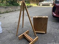 Wooden art easel set components: foldable box easel, adjustable stand, and base support piece
