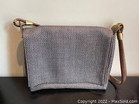 Front view of the rectangular grey grass cloth purse with structured body.