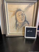 Framed reproduction portrait of a Native American man, showing overall wear and framed under glass.