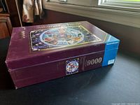 Photo showing the Ravensburger puzzle box closed, with the 9000 piece count visible on the side and top.