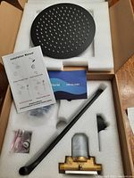 Shower head, rough-in valve, black arm, installation manual and additional accessories packed in foam in box