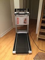 Front view of the Tempo EvolveCompact treadmill showing the running belt and display console.