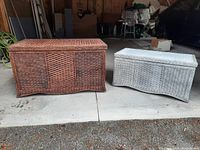Two wicker storage chests side by side, one brown and one white spray-painted, showing full exterior front and top view.