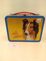 Front view of metal lunch box with large image of Lassie dog and 'The Magic of Lassie' text.