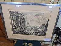 Full view of framed Piranesi print depicting Fontana di Trevi including matting and metal frame.